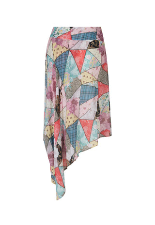 An asymmetrical wrap skirt featuring a colorful patchwork print of geometric triangles and floral patterns in pink, blue, beige, and purple, shown against a plain white background.